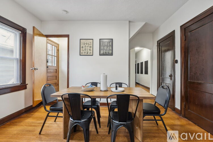 A dining room with a table set for four.