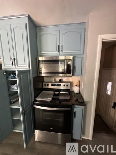 A kitchen with a stove and cabinets.