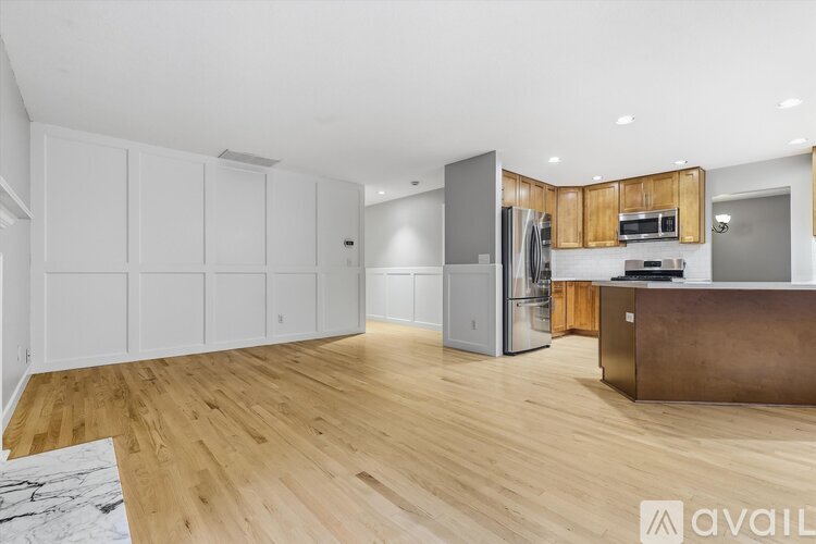 A kitchen with white cabinets and a wooden island.