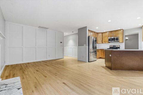 A kitchen with white cabinets and a wooden island.