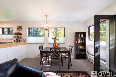 A dining room with a table set for six.