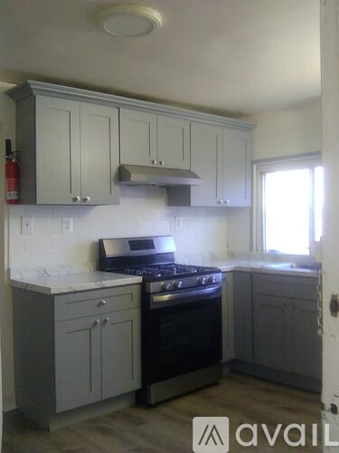 A kitchen with a stove and cabinets.