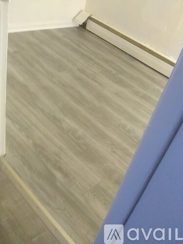 A room with a grey floor and a blue wall.