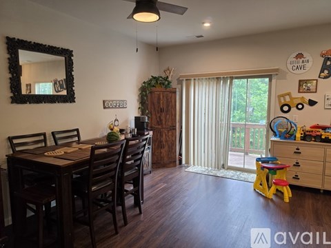 A dining room with a wooden table and chairs.