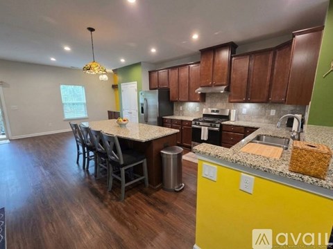 A kitchen with a yellow counter and brown cabinets.