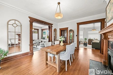 A dining room with a wooden table and chairs.