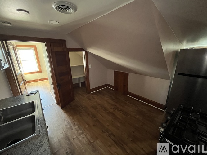A kitchen with a stove top oven and a sink.