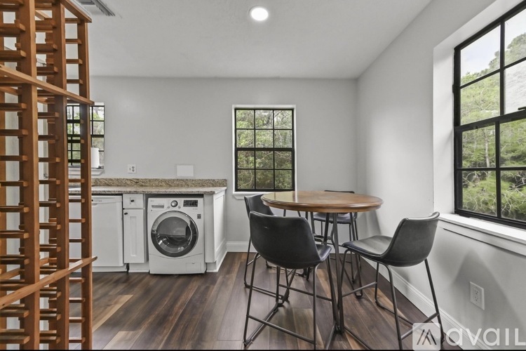 A kitchen with a table and chairs is available.