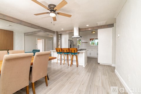 A dining room with a table and chairs.