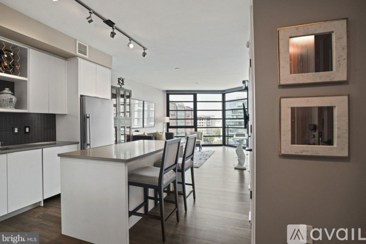 A modern kitchen with white cabinets and a large island.