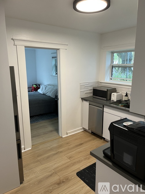 A kitchen area with a microwave on the counter.
