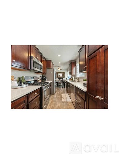 A kitchen with wooden cabinets and a white countertop.