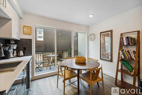 A kitchen with a table and chairs in the middle of the room.