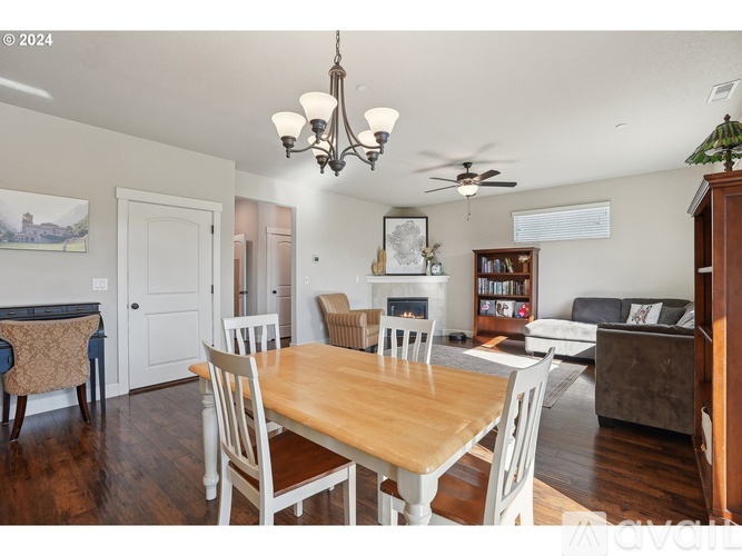 A dining room with a wooden table and chairs.