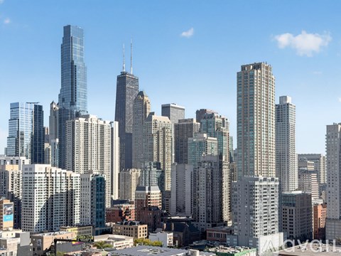 A cityscape with tall buildings and a clear sky.