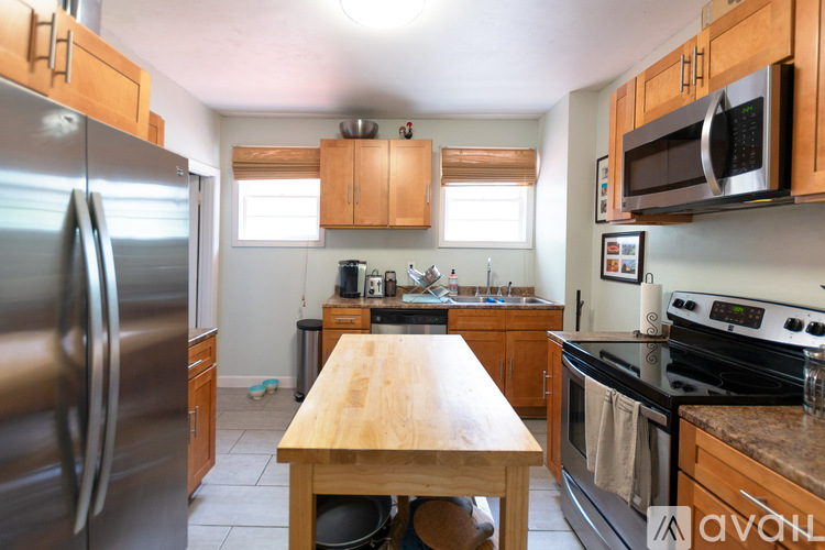 A kitchen with wooden cabinets and stainless steel appliances.