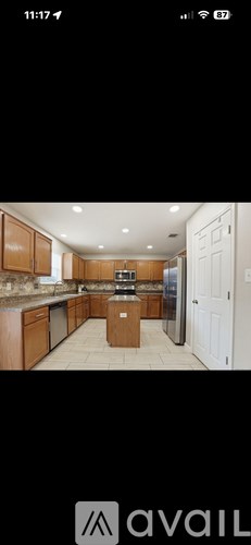 A kitchen with wooden cabinets and a central island.