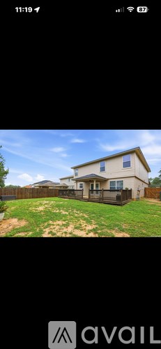 A house with a fence and a grassy yard.