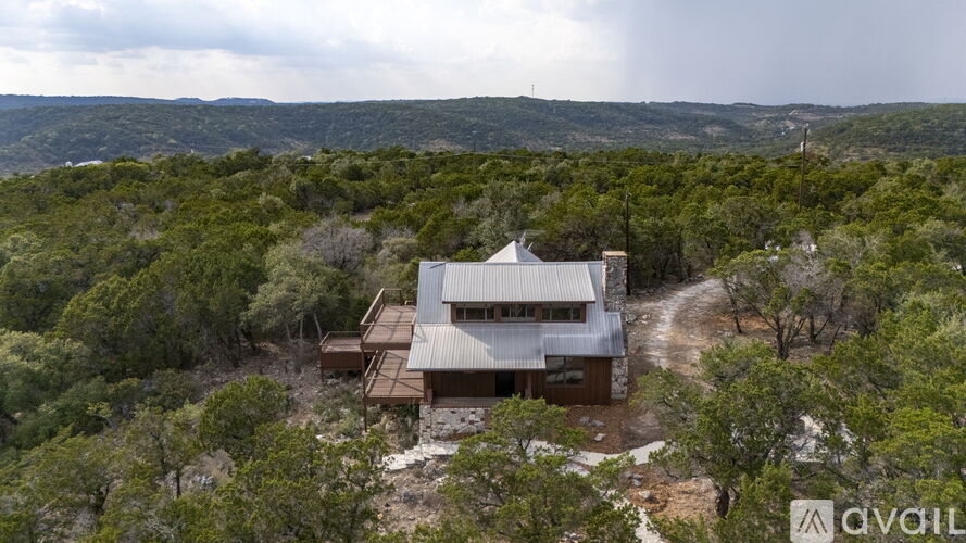 A house is surrounded by trees in a wooded area.
