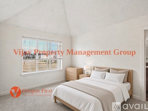 A bedroom with a large bed and a window overlooking a balcony.