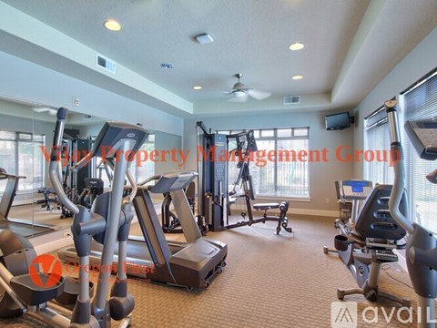 A gym with treadmills, elliptical machines, and other exercise equipment.