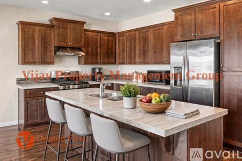 A kitchen with wooden cabinets and a marble countertop.