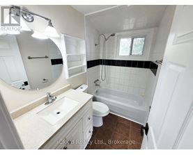 A bathroom with a sink, toilet, and bathtub.
