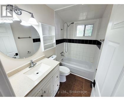 A bathroom with a sink, toilet, and bathtub.