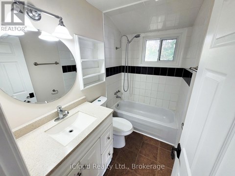A bathroom with a sink, toilet, and bathtub.