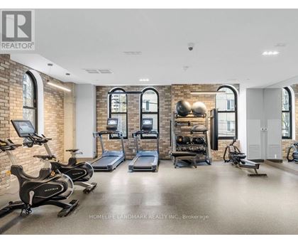 A gym with a brick wall and exercise equipment.