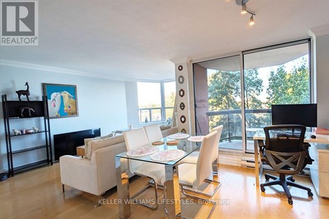 A living room with a glass table and chairs.