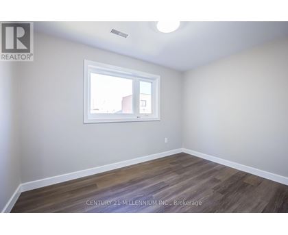 A room with a window and wooden flooring.