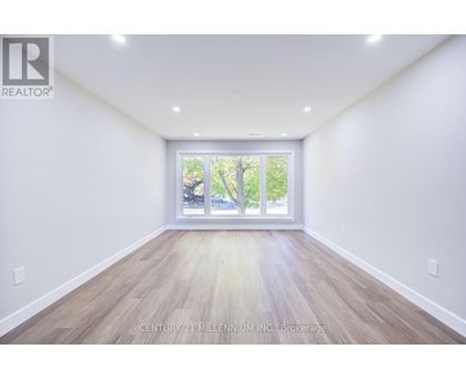A spacious room with Century 21 Millennium Inc. Brokerage watermark.