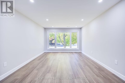 A spacious room with Century 21 Millennium Inc. Brokerage watermark.