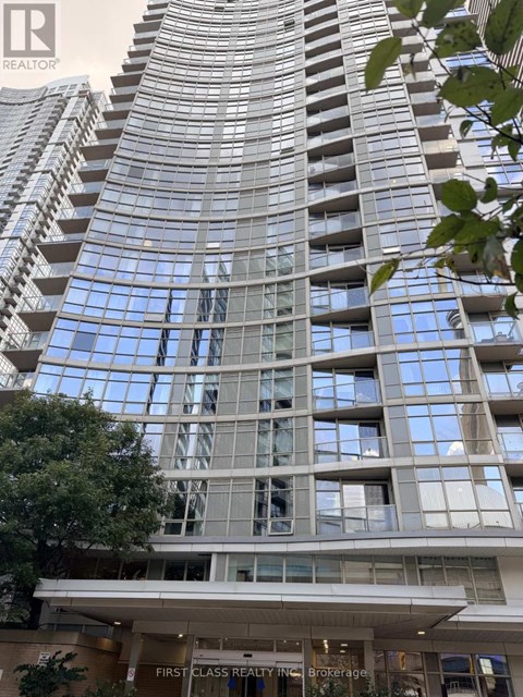 A tall building with many windows and a sign that says "First Class Realty Brokerage".