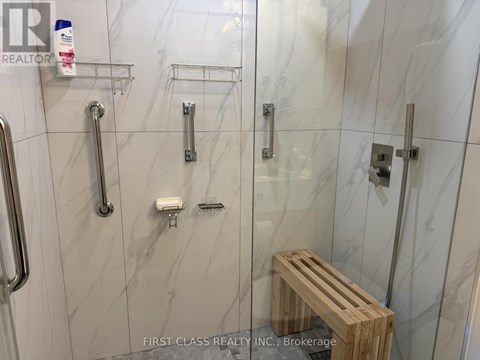 A shower area with a bench and a shelf.