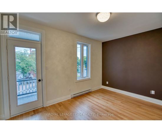 A room with a brown wall and a white door.