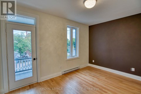 A room with a brown wall and a white door.