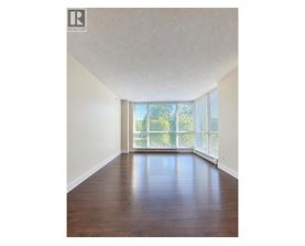 A room with wooden floors and a large window.