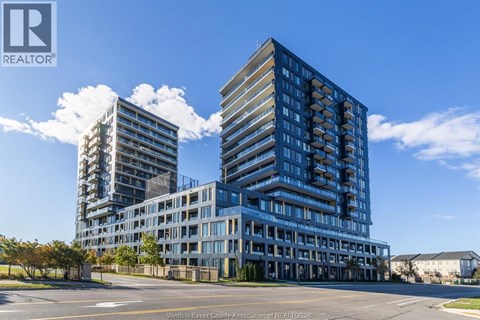 A modern building complex with a clear blue sky above.