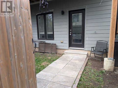 A house with a black door and a wooden fence.