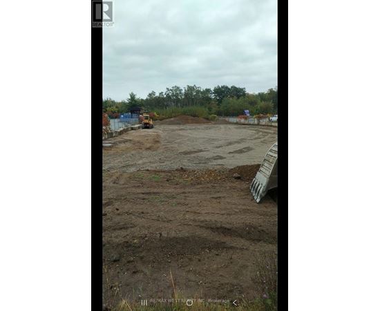 A construction site with a bulldozer and a pile of dirt.