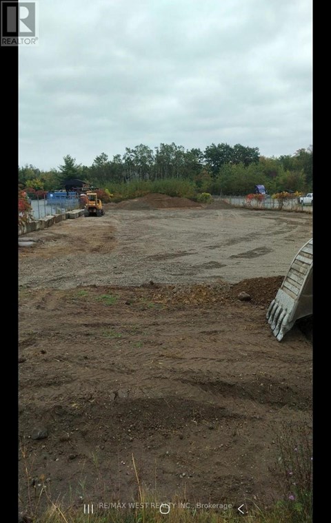A construction site with a bulldozer and a pile of dirt.