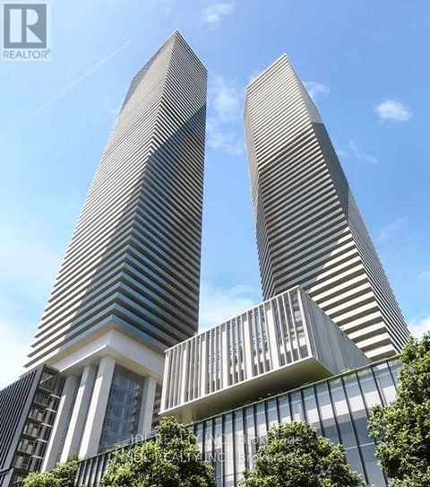 Two tall buildings with striped facades stand next to each other.