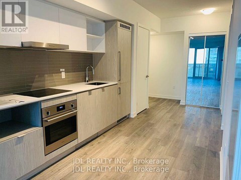 A kitchen with wooden cabinets and a stainless steel oven.