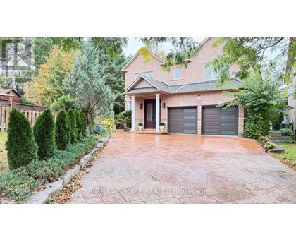 A house with a driveway and garage doors is for sale.