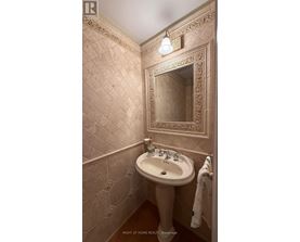 A bathroom with a sink and a mirror.
