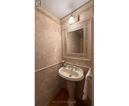 A bathroom with a sink and a mirror.