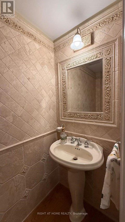 A bathroom with a sink and a mirror.