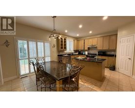 A kitchen with a table and chairs in the middle of the room.